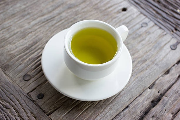 istock Hot green tea on wood table. 536016049