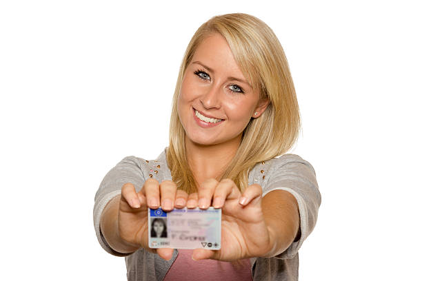 istock Young woman showing her driver's license 536017503