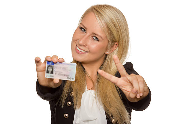 istock Young woman showing her driver's license 536017655