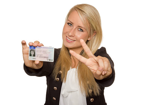 istock Young woman showing her driver's license 536017659