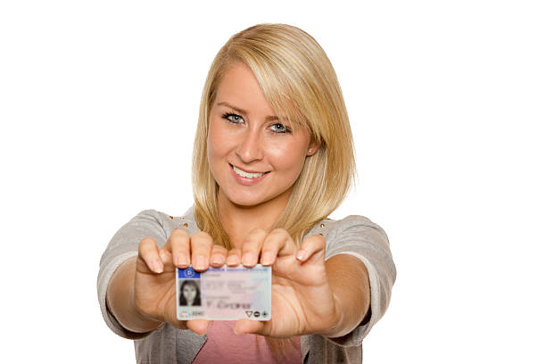 istock Young woman showing her driver's license 536017663