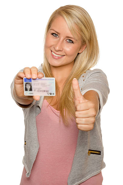 istock Young woman showing her driver's license 536017669