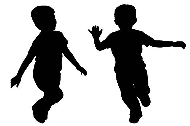 Silhouettes of two little boys who run