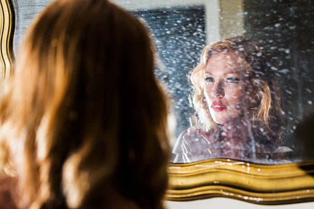istock Young woman applying lipstick in bathroom 536018807