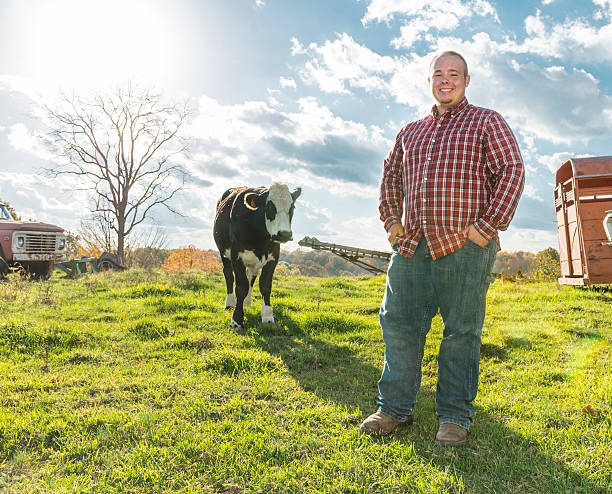 istock Proud young man with the calf he is raising 536026649