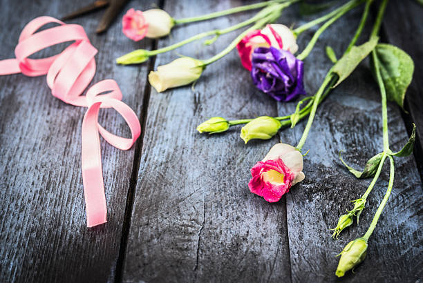 istock Flowers with ribbon on old blue wooden table 536027945