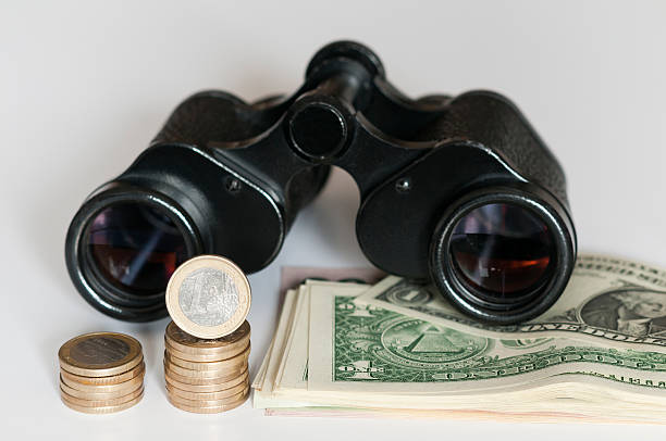 istock Euro and US Dollar with binoculars 536028867