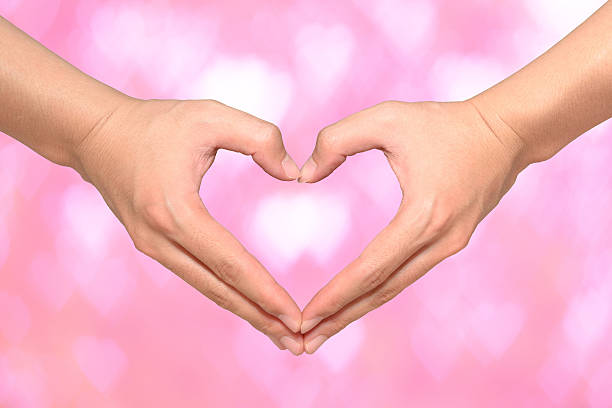istock Heart made by hands on pink heart bokeh background 536029149