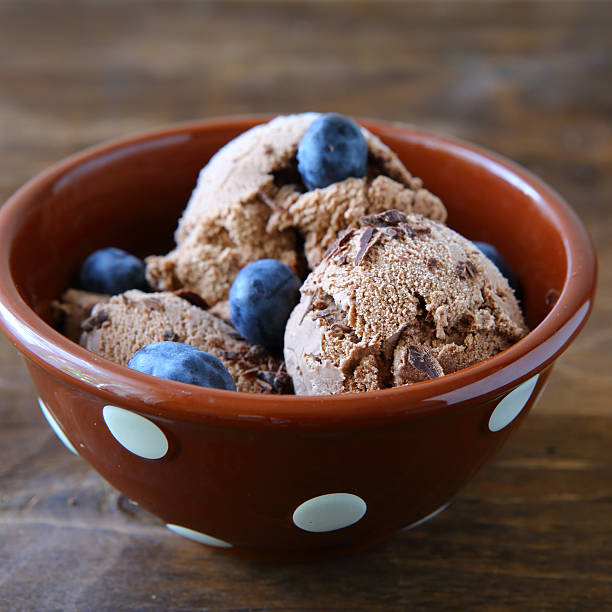 istock ice cream with berries in a bowl 536030023