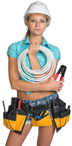 istock Pretty electrician in helmet, shorts, shirt, tool belt with tools 536030161
