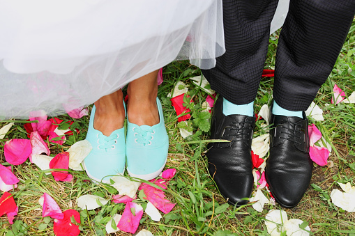 Legs bridal, groom wearing shoes, bride's moccasins