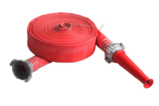 Rolled up red fire fighting hose with coupler and nozzle, Isolated on white background.