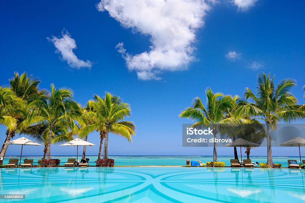 Tropical resort Tropical beach resort with  lounge chairs and umbrellas in Mauritius Tourist Resort Stock Photo