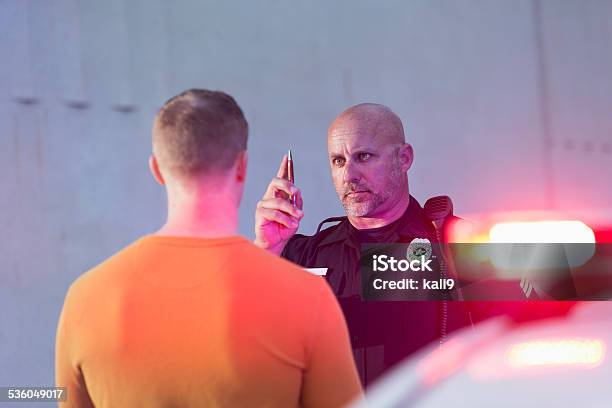 Policeman Performing Sobriety Test On Driver Stock Photo - Download Image Now - Drunk Driving, Arrest, Police Force