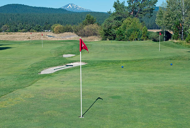 Practice putting greens at golf course in central Oregon with Mount Bachelor in background