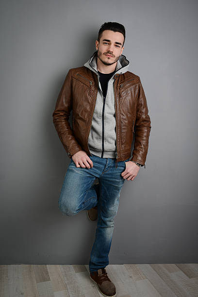 istock handsome young trendy man in brown leather jacket 536050705