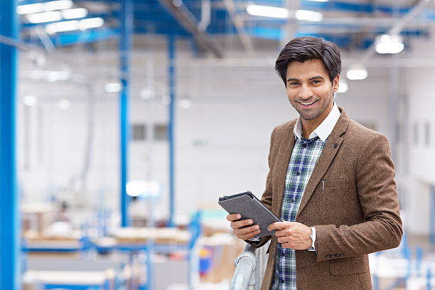 feliz jovem empresário com tablet digital em armazém - warehouse manager place of work portrait - fotografias e filmes do acervo