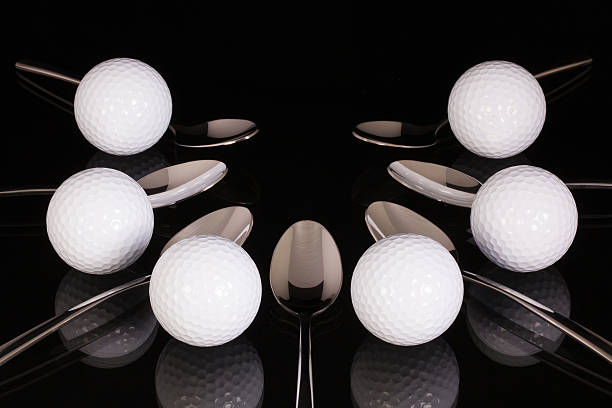 istock Teaspoons and golf equipments on the black glass table 536052641