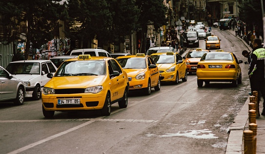 Istanbul, Turkey - October 26, 2014: yellow taxi in siraselviler cadessi nearby Taksim Park.