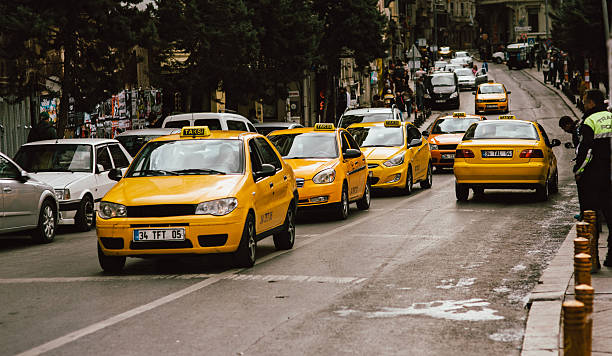 yellow taxi in Istanbul Istanbul, Turkey - October 26, 2014: yellow taxi in siraselviler cadessi nearby Taksim Park. yellow taxi cab stock pictures, royalty-free photos & images