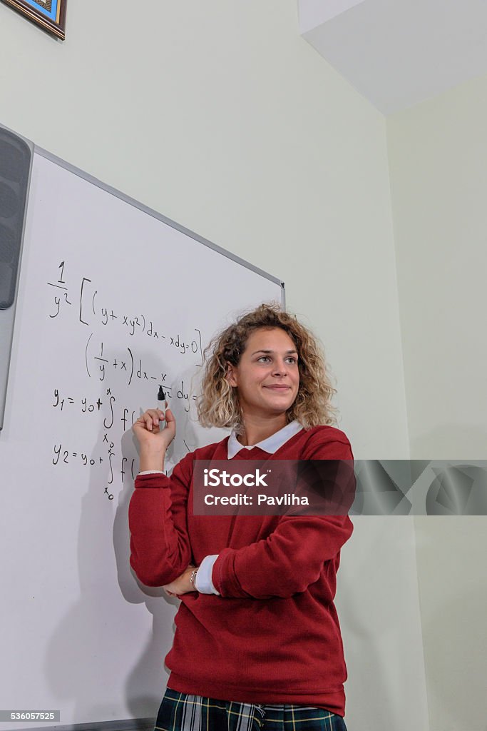 Young Woman Doing Math at Secondary School, University inIstanbul, Turkey Female student doing math at the whiteboard, Istanbul, Turkey. Nikon D3x 20-24 Years Stock Photo