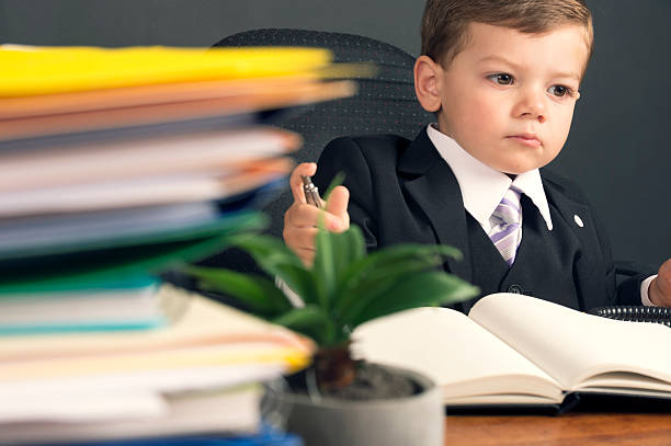 istock Humorous business manager concept. Young child in a suit working 536057649