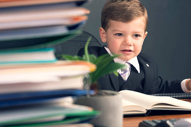 istock Humorous business manager concept. Young child in a suit working 536057759