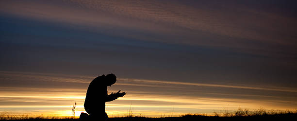 istock One Man Praying Outside Against Beautiful Sunrise 536059013