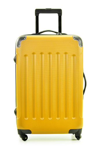 Large yellow polycarbonate suitcase isolated on white background
