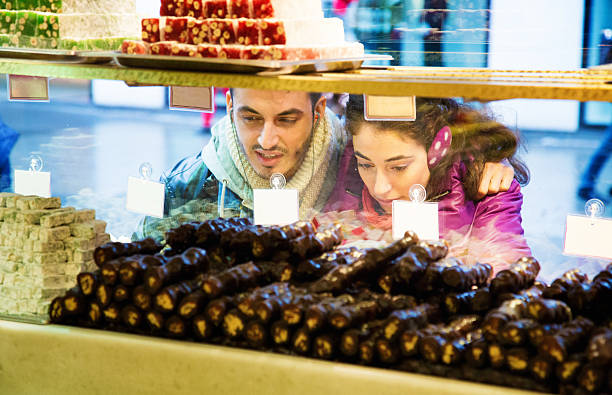 Young couple window shopping for Turkish delight or loukoum in Istanbul.