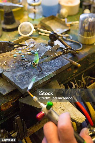 Jeweler Heating Piece Of Gold At Jewelers Workbench Stock Photo - Download Image Now