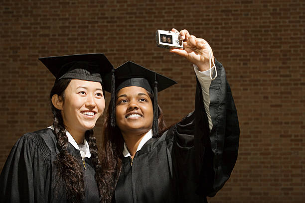 Two female graduates taking a photograph