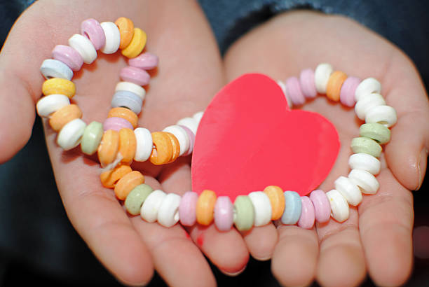 heart and sweet necklace in hands