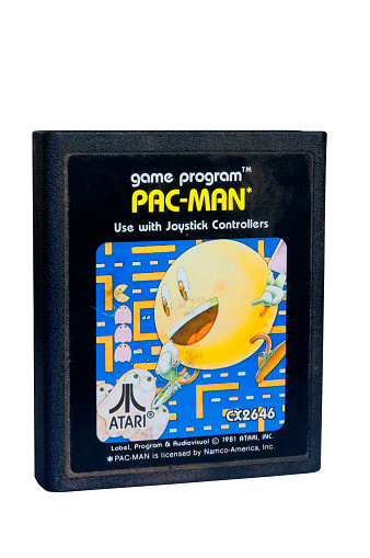 Adelaide, Australia - February 06 2015: A Studio shot of an Atari 2600 Pac-Man Game Cartridge. A popular video game from the 1980's is popular with collectors and retro gamers worldwide.