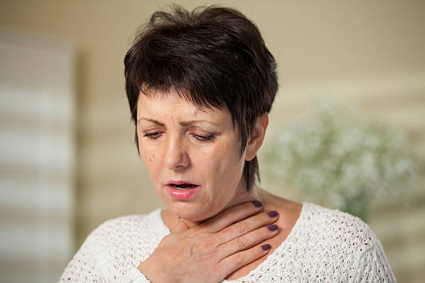 Woman with sore throat stock photo