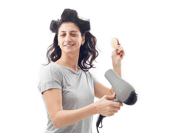 istock Young woman holding blow dryer 536080797