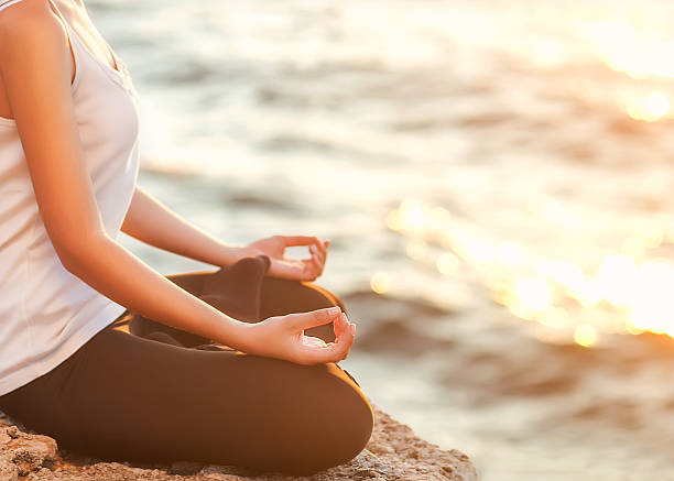 istock girl in lotus pose at sunset 536080945