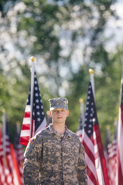 istock American Soldier standing in front of American Flags 536090838