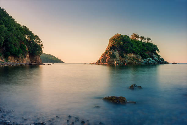 istock small rocky island while sunrise at ocean in italy 536091391