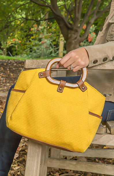 istock Woman holding yellow purse 536091735