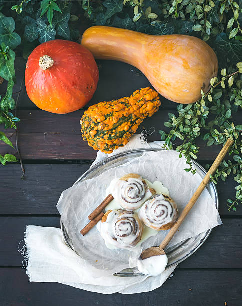 istock Cinnamon pumpkin buns with creamy cheese icing and ripe pumpkins 536093027