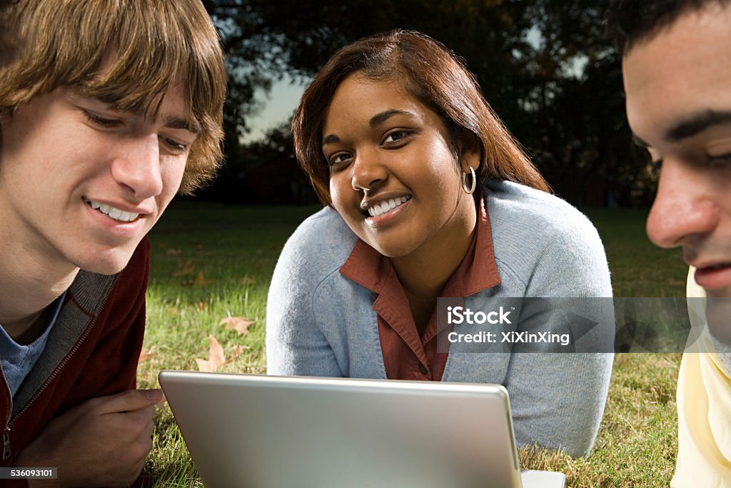 Three students studying outdoors 2015 Stock Photo