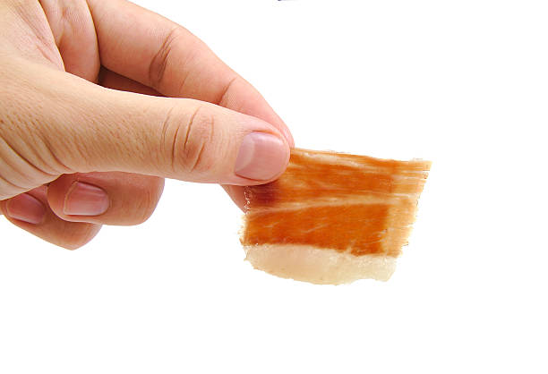 istock Man holding a hand cut serrano ham slice isolated on 536093159