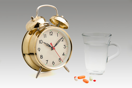 Alarm Clock, Pills  With Glass Of Water.