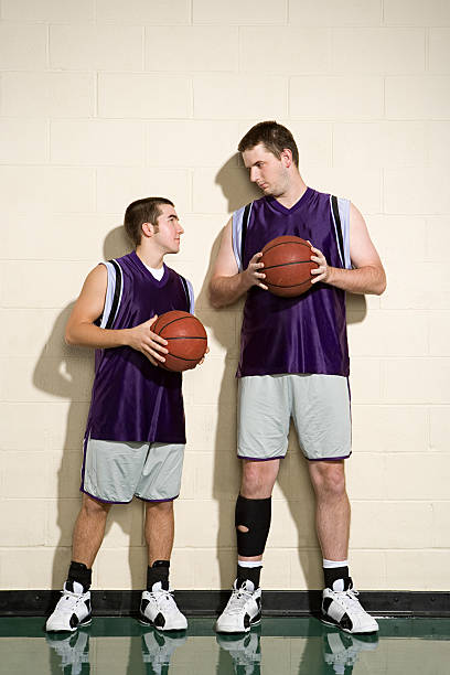 tall and short basketball players - kort längd bildbanksfoton och bilder