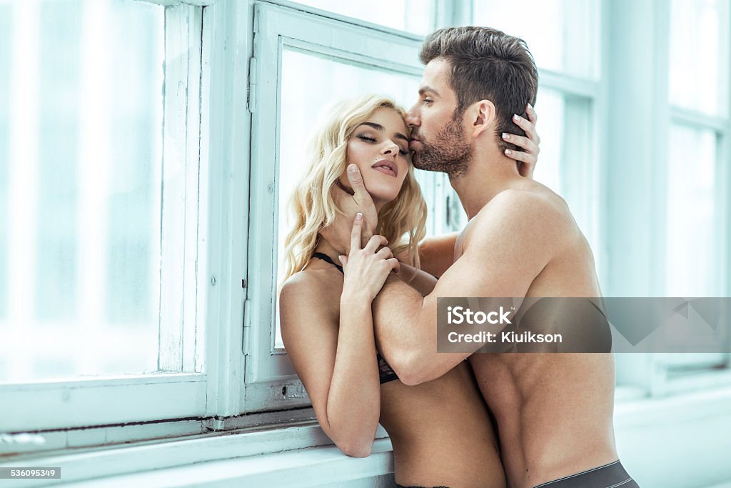 Handsome man kissing blond beauty Couple - Relationship Stock Photo