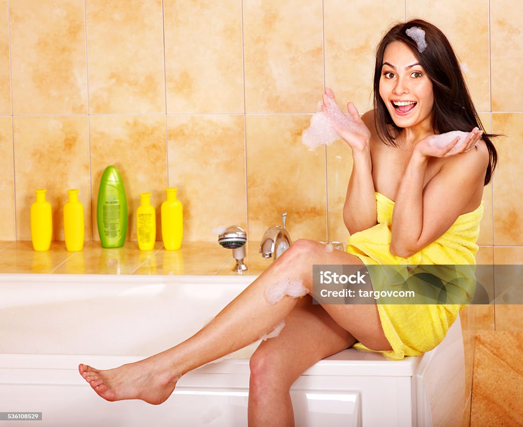 Woman take bubble  bath Young woman take bubble  bath. Happy girl with bare feet. 2015 Stock Photo