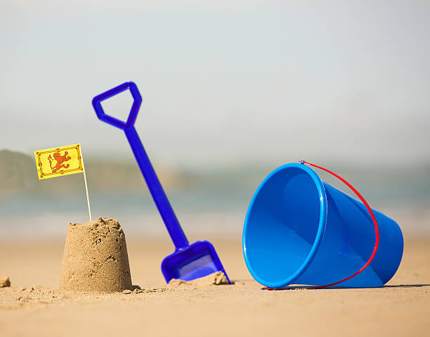istock Beach, sea with bucket spade sandcastle and welsh flag 536109093