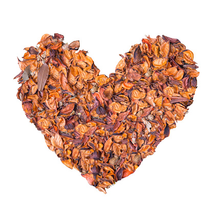 orange potpourri arrange to heart shape on white background