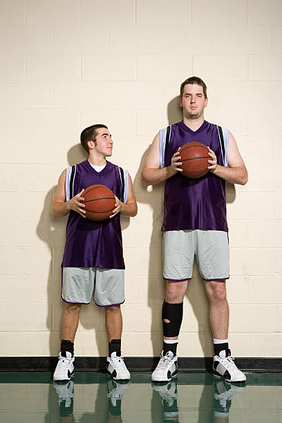 Tall and short basketball players stock photo